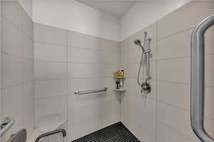 Bathroom featuring a tile shower