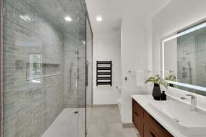 Bathroom with vanity, a shower stall, recessed lighting, and tile patterned flooring