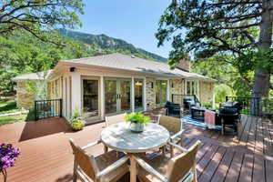 Wooden deck with french doors, a mountain view, outdoor dining space, and outdoor lounge area
