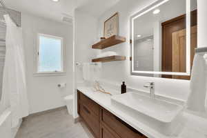 Full bathroom featuring vanity, recessed lighting, tile patterned flooring, and shower / bath combo