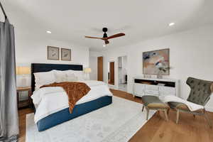 Bedroom featuring recessed lighting, wood finished floors, a ceiling fan, and connected bathroom