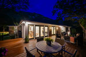 Deck at twilight with outdoor dining space