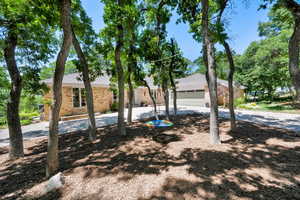 Single story home featuring brick siding and a shingled roof