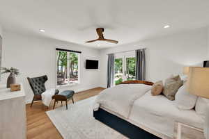 Bedroom with multiple windows, light wood-type flooring, recessed lighting, and ceiling fan