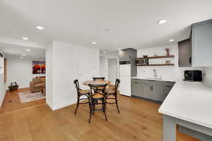 Dining area featuring light wood finished floors and recessed lighting