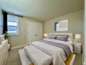 2nd Bedroom featuring light carpet and baseboards