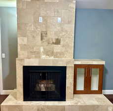 Detailed view of a fireplace and baseboards