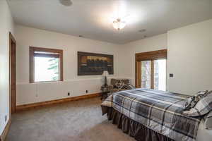 Bedroom featuring carpet and baseboards