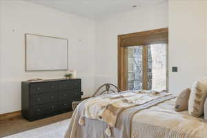 Bedroom featuring carpet flooring and baseboards