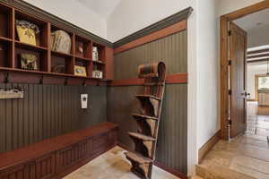 Mudroom with stone tile flooring