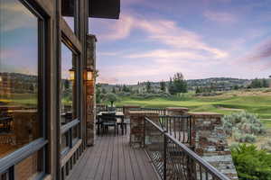 Deck featuring outdoor dining space and golf course view