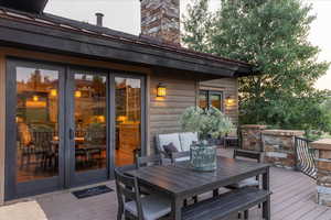 Wooden terrace featuring outdoor dining area