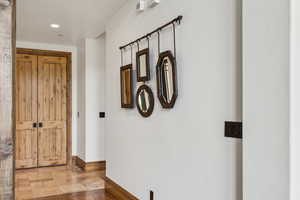 Hallway with recessed lighting and baseboards