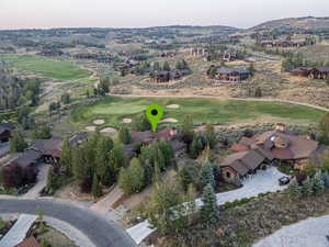 Aerial overview of property's location with a golf club and nearby suburban area