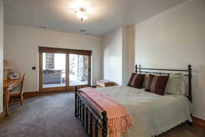 Bedroom with access to outside and carpet