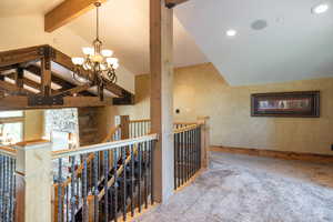 Corridor with an upstairs landing, carpet, a chandelier, and recessed lighting