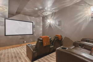 Home theater with baseboards and light wood finished floors