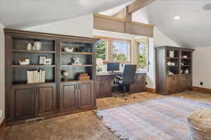 Office with light colored carpet and recessed lighting
