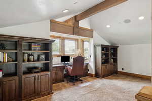 Office space with vaulted ceiling, light colored carpet, and recessed lighting
