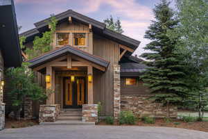 Exterior entry at dusk with a standing seam roof, a metal roof, and board and batten siding