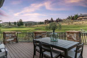 Deck featuring outdoor dining area and golf course view