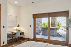 Bedroom with access to outside, a desk, and recessed lighting