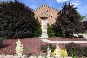 View of front of property with entry steps and brick siding