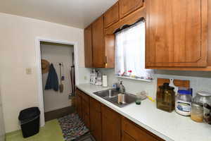 Kitchen featuring light countertops and brown cabinetry