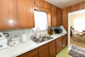 Kitchen with light countertops and brown cabinets