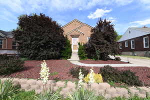 Obstructed view of property with brick siding
