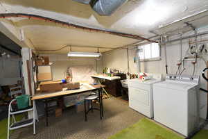 Basement with washer and dryer and a workshop area
