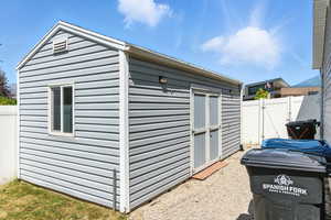 View of shed featuring a gate