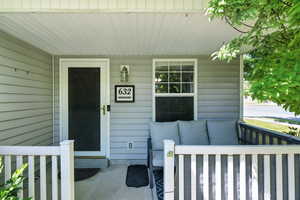Doorway to property featuring a porch