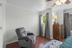 Sitting room featuring ceiling fan, wood finished floors, crown molding, and a textured ceiling