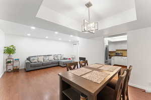 Dining room with recessed lighting, wood finished floors, and a chandelier