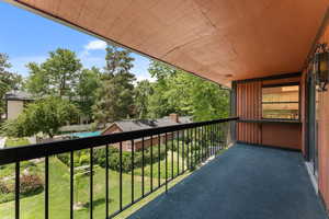 Balcony with view of wooded area