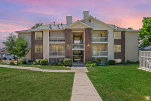 View of property at dusk