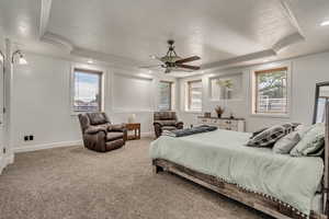 Bedroom with ornamental molding, a raised ceiling, carpet flooring, recessed lighting, and ceiling fan