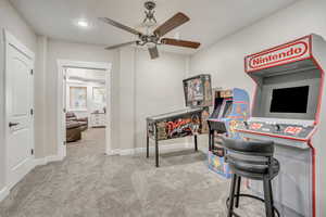 Carpeted home office featuring a ceiling fan and recessed lighting