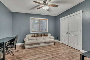 Office space with a ceiling fan and wood finished floors