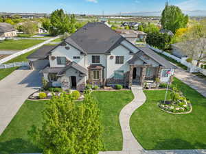 View of front of home featuring stone siding, stucco siding, a shingled roof, concrete driveway, and a residential view