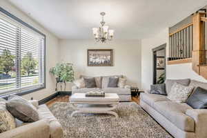 Living room featuring a chandelier and wood finished floors