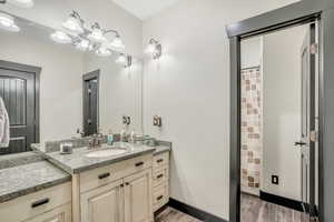 Bathroom featuring wood finished floors, vanity, and a shower with curtain
