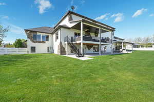 Rear view of property with a ceiling fan, stairs, a patio, stucco siding, and stone siding