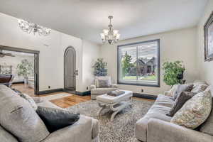 Living area with a chandelier and light wood-style flooring