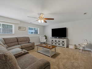 Living area featuring carpet floors and a ceiling fan