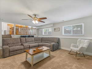Living room with carpet floors and a ceiling fan