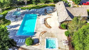 Aerial view of property and surrounding area featuring a pool