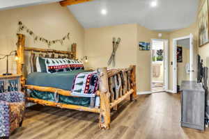 Bedroom with wood finished floors, recessed lighting, and beamed ceiling