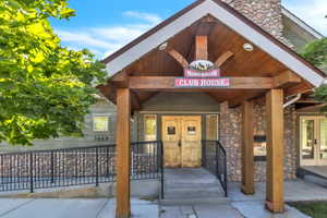 Entrance to property featuring stone siding